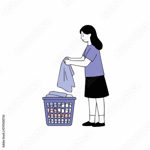 Girl placing towel in laundry basket