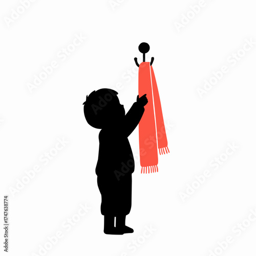 Child hanging scarf on hook