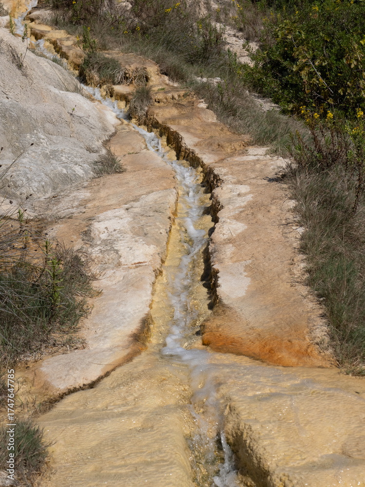 Obraz premium Parco naturale dei Mulini, public park with hot springs and dismantled system of grain mills at Bagno Vignoni, town in the province of Siena, Italy 