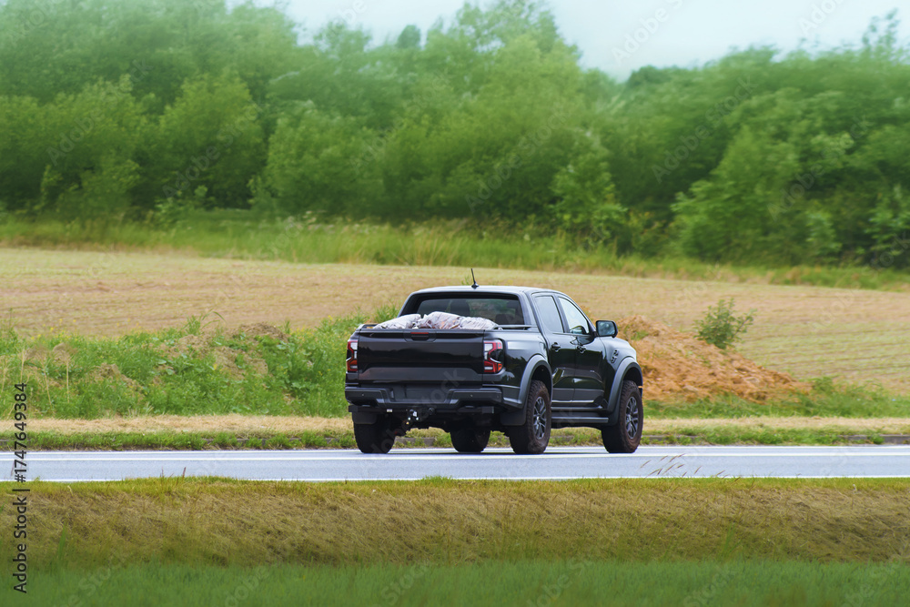 Fototapeta premium Pickup truck crossing rural scenic highway