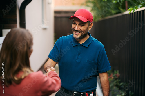Fotografía Happy home repairman responding to customer's call.