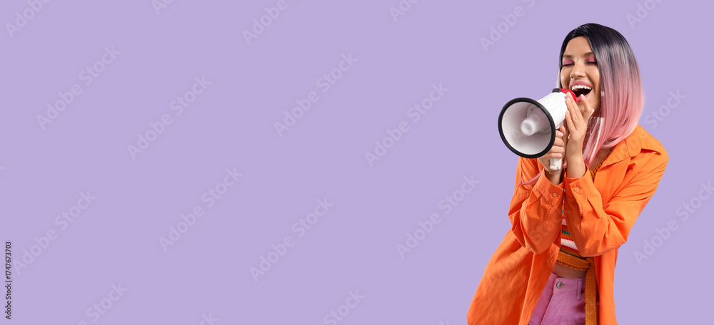 Obraz premium Beautiful young happy woman in pink wig with megaphone on purple background