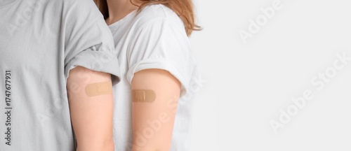 фотографія Young couple with applied medical patches on light background with space for text, closeup