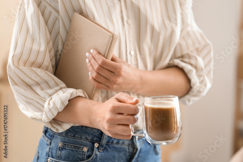 Woman holding coffee mug an...