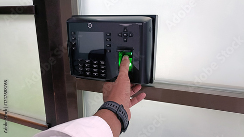 using thumbs to fill in attendance at the office with the attendance machine