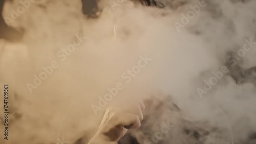 a man smoking a vape with a lot of smoke coming out