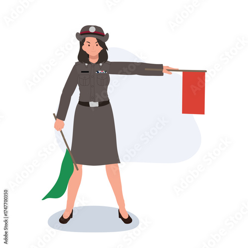 female thai traffic officer in uniform signaling with red and green flags for transportation safety theme
