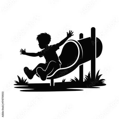 Child silhouetted sliding down a playground slide