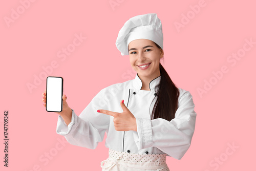 Young female chef pointing ...