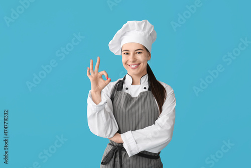 Young female chef showing o...