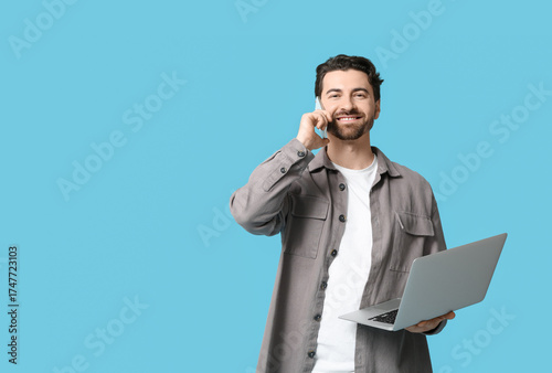 Young man with laptop talki...