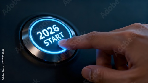 Finger pressing illuminated 2026 start button