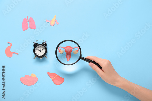 Female hand magnifying pape...