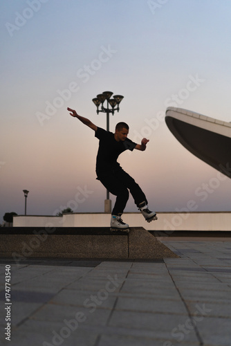 Man performing a trick on roller skates at sunset, urban environment