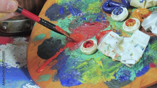 Wallpaper Mural The hands of the artist, work to create creative images in art. Art paints and brushes, applying multi-coloured strokes to the canvas using palette, gouache and watercolour. Torontodigital.ca