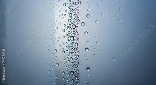 Fresh water droplets creating abstract patterns on glass, perfect for clean beauty product backgrounds