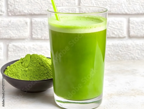 Wallpaper Mural Vibrant green matcha latte in glass with powder on white background Torontodigital.ca