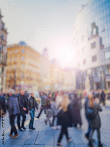 Crowd of anonymous people walking on busy city street