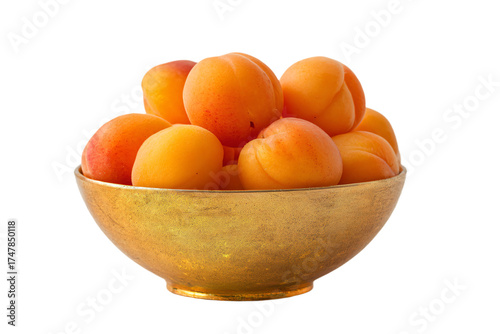 A golden textured bowl filled with fresh ripe apricots.