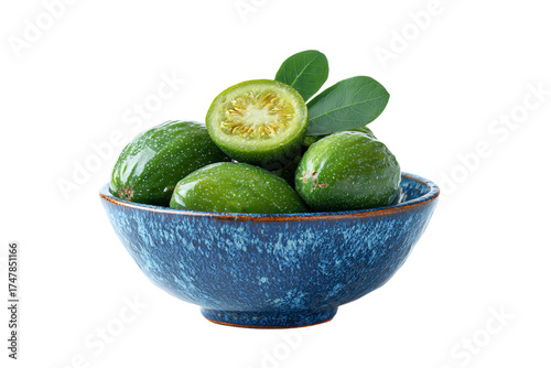 Fresh green calamansi citrus fruits in a blue ceramic bowl.