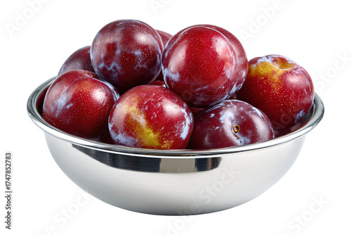 Fresh ripe red plums in a shiny silver bowl.
