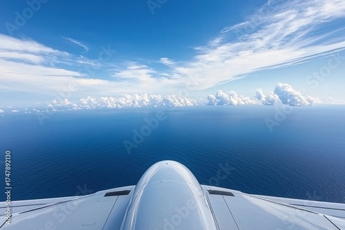 Aerial View from Airplane Over Vast Ocean and Bright Blue Sky