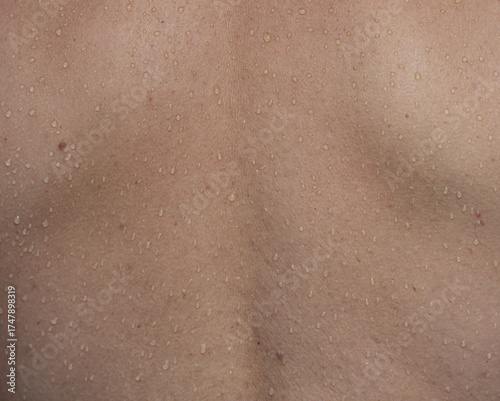 A person's back with water droplets on it