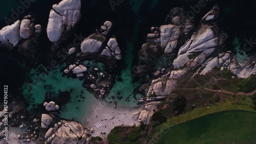 Aerial view of the striking contrast between the turquoise waters and the dark rocky coastline, Cape Town, Western Cape, South Africa.