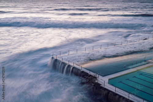 Wallpaper Mural Bondi Ocean pool in early morning dawn sunrise light, Australia outdoor healthy swimming lifestyle, waves crashing and pouring over side Torontodigital.ca