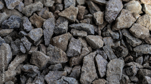 Close-up of compact gravel surface with mixed stone colors and rough texture. Ideal for construction, landscaping, groundwork, and material background themes.