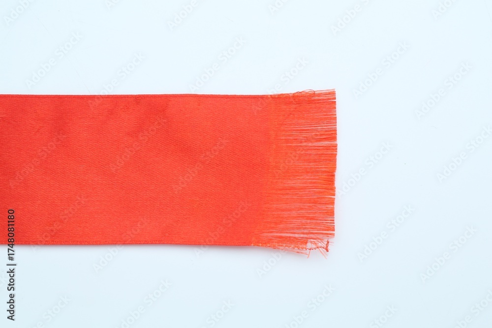 Fototapeta premium Beautiful red ribbon on white background, top view. Space for text