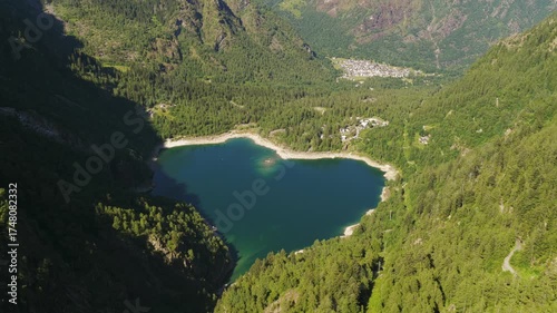 Lake Antrona, Italy, scenic aerial of pine forests and mountain lake with village