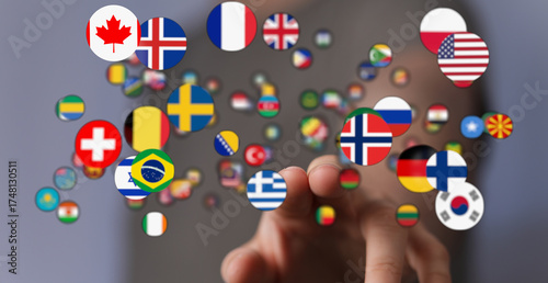 Concept image of a hand interacting with multiple international flags, representing global connections, internationalism, and worldwide unity. I