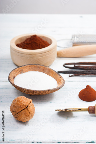 walnut, cookie cutter and dessert baking ingredients on white wooden