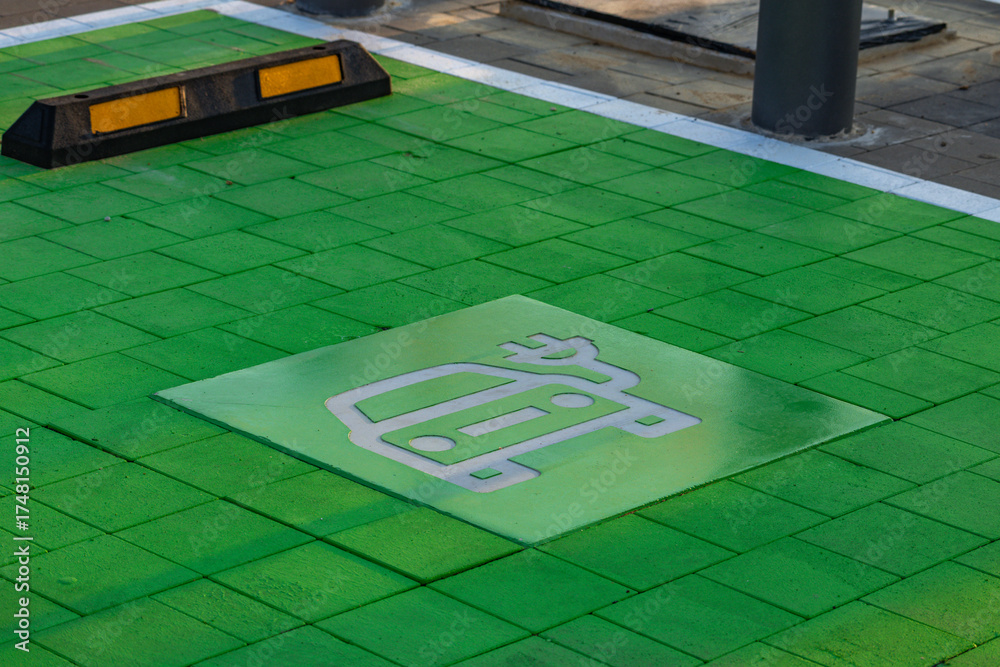 Obraz premium Electric vehicle parking space with green pavement marking