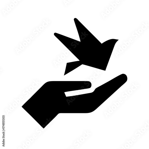 Hand releasing a paper bird