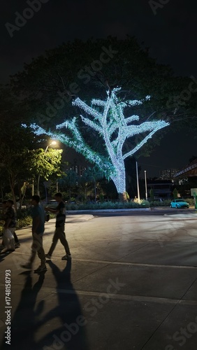 Photography Trees with glowing lights at Titiwangsa Lake Park Kuala Lumpur with dark sky at