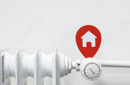 Red location pin with a hou...