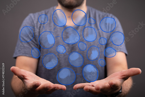 Abstract image of a man presenting a network of interconnected blue circles, symbolizing connection, teamwork, and global communication.