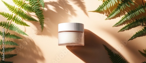 Cream jar held surrounded by leaves in sunlight