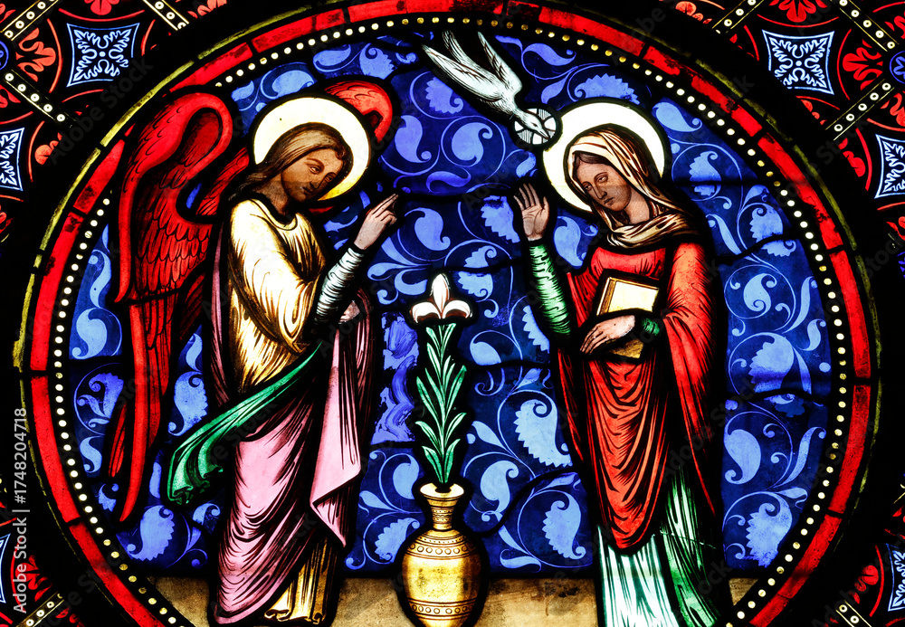 Fototapeta premium Bayeux cathedral. Stained glass. Stained glass window depicting the Annunciation, the moment when the Angel Gabriel announces to the Virgin Mary that she will conceive Jesus. Bayeux. France.