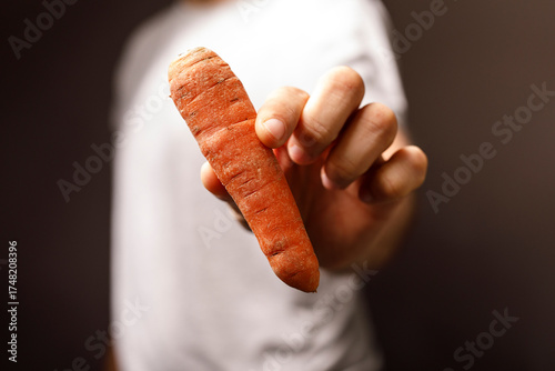 A person's hand holding a f...