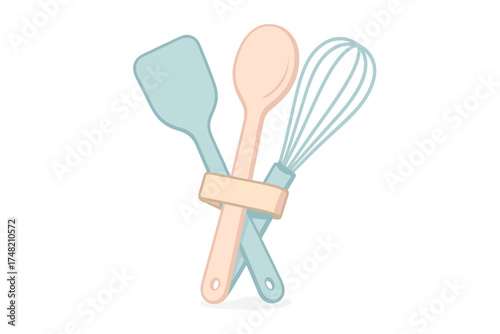 Set of essential kitchen baking tools including spatula wooden spoon and wire whisk tied with ribbon