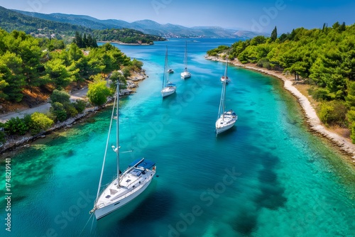Sailboats dotting clear turquoise water in a croatian bay