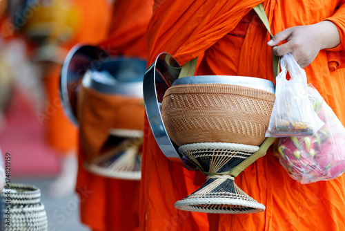 Photos Close of Buddhist novice monks carrying their alms bowls for going on alms round in early morning