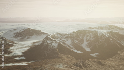 Schilderij op canvas Mountain peaks stretch across the horizon, bathed in gentle sunlight