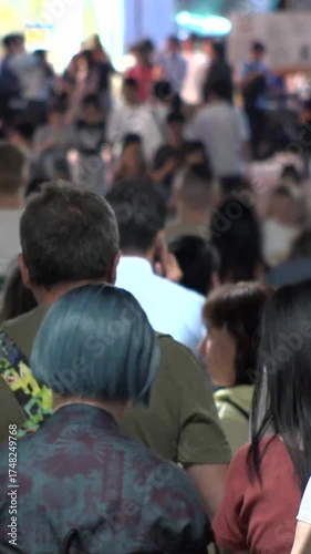 TOKYO, JAPAN - AUG 2025 : Crowd of people walking at busy downtown area. Time lapse shot in busy night rush hour. Japanese people, urban city life and lifestyle concept vertical video.