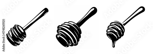 Three classic wooden honey dippers with grooves designed for collecting and drizzling sweet honey