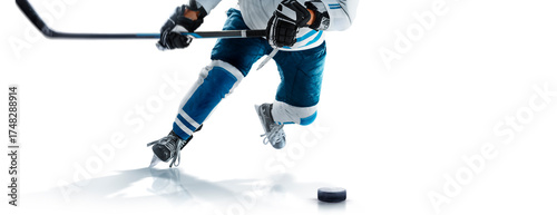 Hockey player in action close-up. A hockey player prepares to throw the puck. Isolated. Hockey skates, stick and puck close-up. Hockey concept