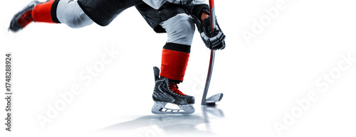 Hockey. Close-up of hockey skates, stick, and puck. Hockey player on the rink at high speed. Focus on the puck. Hockey player in action. Hockey isolated